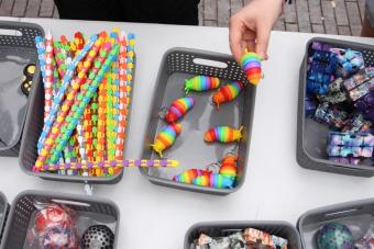 Someone tests out a fidget in a basket during Fidget Friday.
