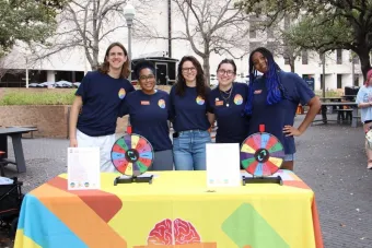 NDatUT student staff and Longhorn TIES professional staff smile at a Fidget Friday event