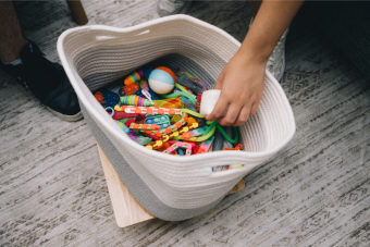Hand reaching into a box of fidgets.
