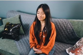 Student meditating, with eyes closed.