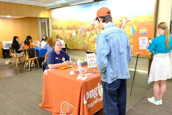 Longhorn TIES staff provide information to a student